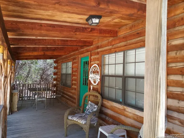 a room with wooden floor table and chairs