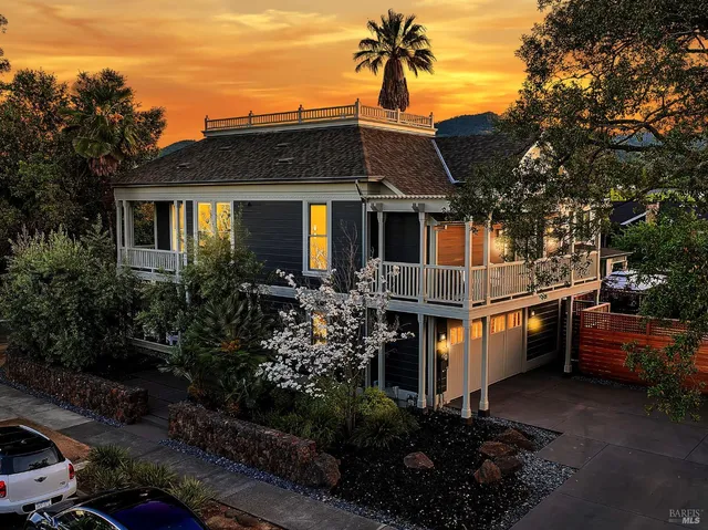 a front view of a house with a garden