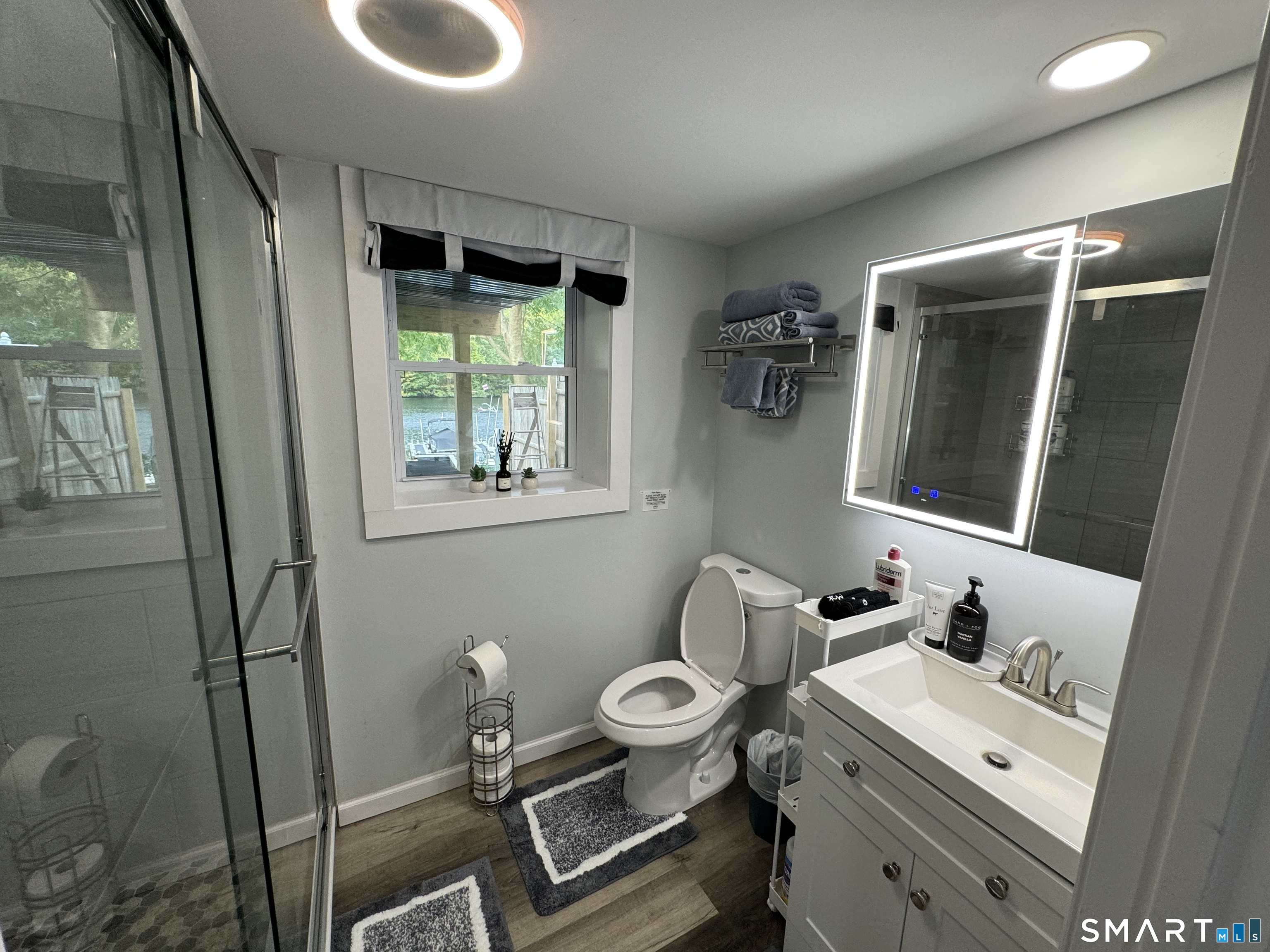 7 Pootatuck Park Road Newtown, CT 06482 - Photo 15 of 25 a bathroom with a toilet sink and mirror