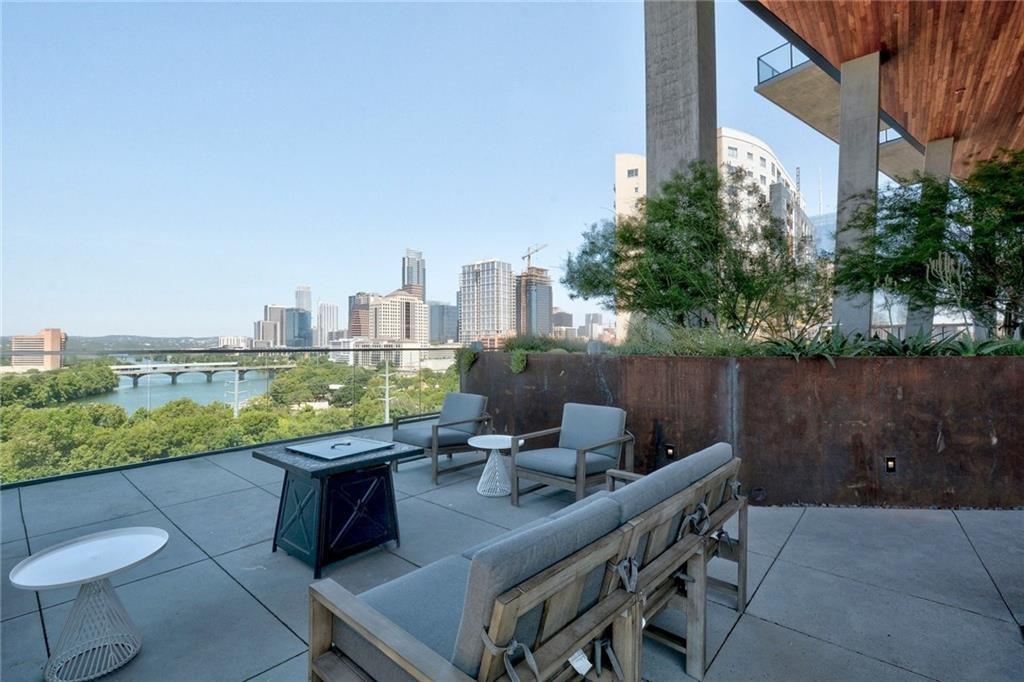 70 Rainey Street, Unit 1409 Austin, TX 78701 - Photo 30 of 38 View of patio / terrace with a skyline view, outdoor furniture, and a water view