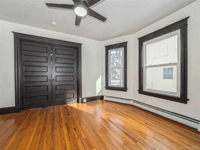 a view of a room with wooden floor and window