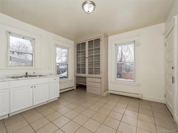 a bathroom with a granite countertop sink mirror and a bathtub