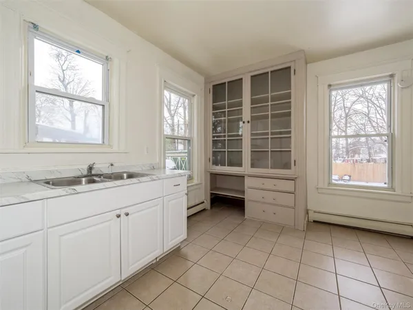 a bathroom with a window sink and mirror