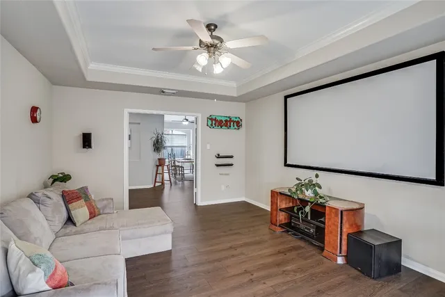 a living room with furniture and wooden floor