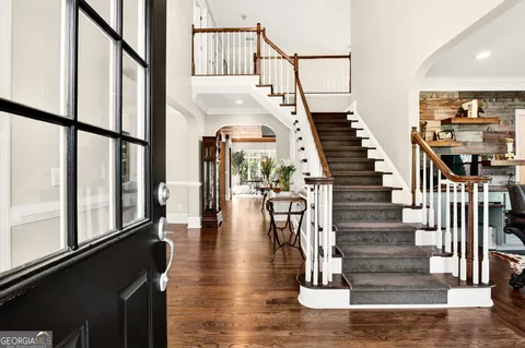 a bathroom with a granite countertop sink a toilet and shower