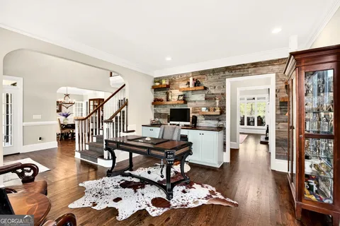 a room with a table chairs and wooden floor