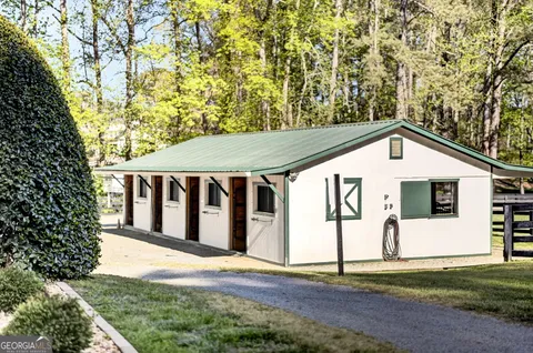 a living room with furniture and floor to ceiling windows