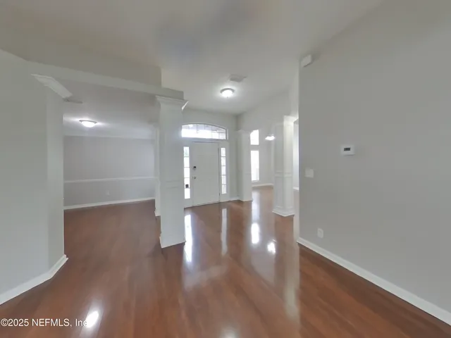 a view of a hallway with wooden floor