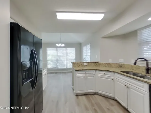 a kitchen with a sink stainless steel appliances and cabinets