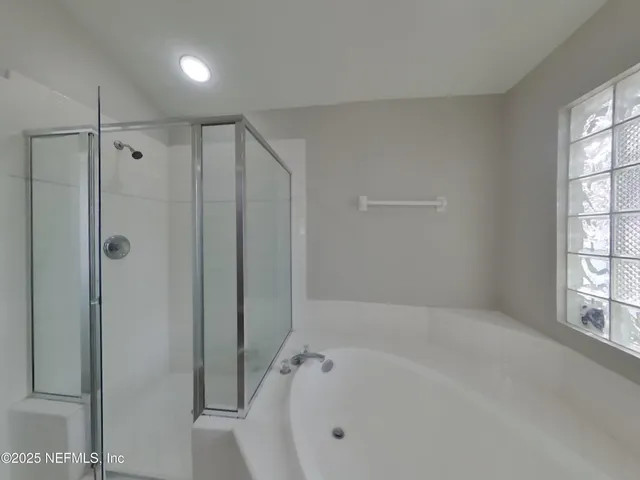 a bathroom with a bathtub and a shower
