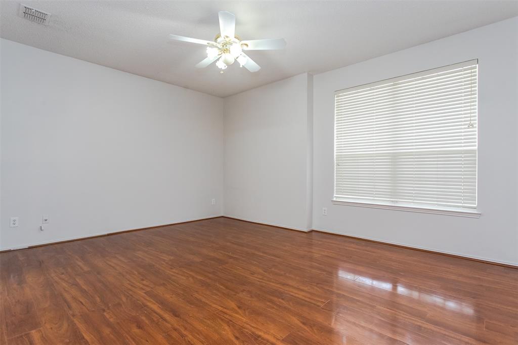 738 Opal Lane Mesquite, TX 75149 - Photo 10 of 31 Unfurnished room with dark wood-style flooring and ceiling fan