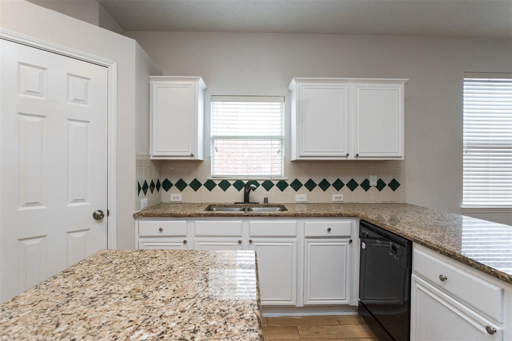 738 Opal Lane Mesquite, TX 75149 - Photo 15 of 31 Kitchen with white cabinets, dishwasher, light stone counters, and tasteful backsplash