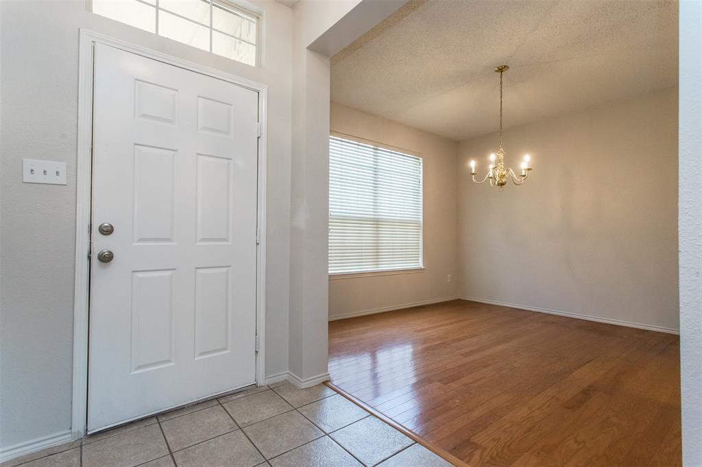 738 Opal Lane Mesquite, TX 75149 - Photo 2 of 31 Foyer entrance with a textured ceiling, a chandelier, and light tile patterned floors