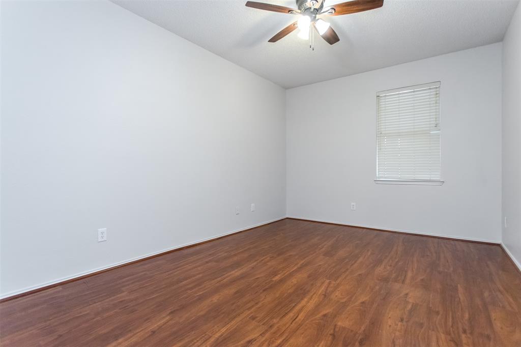 738 Opal Lane Mesquite, TX 75149 - Photo 21 of 31 Unfurnished room featuring dark wood finished floors and ceiling fan