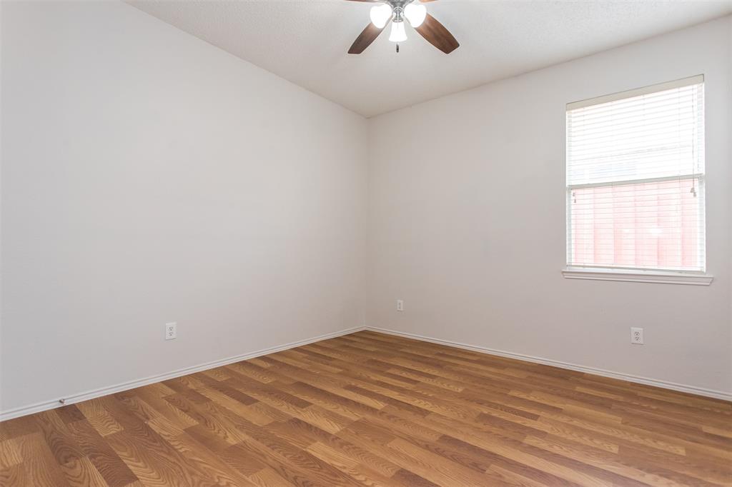 738 Opal Lane Mesquite, TX 75149 - Photo 24 of 31 Spare room featuring wood finished floors and ceiling fan