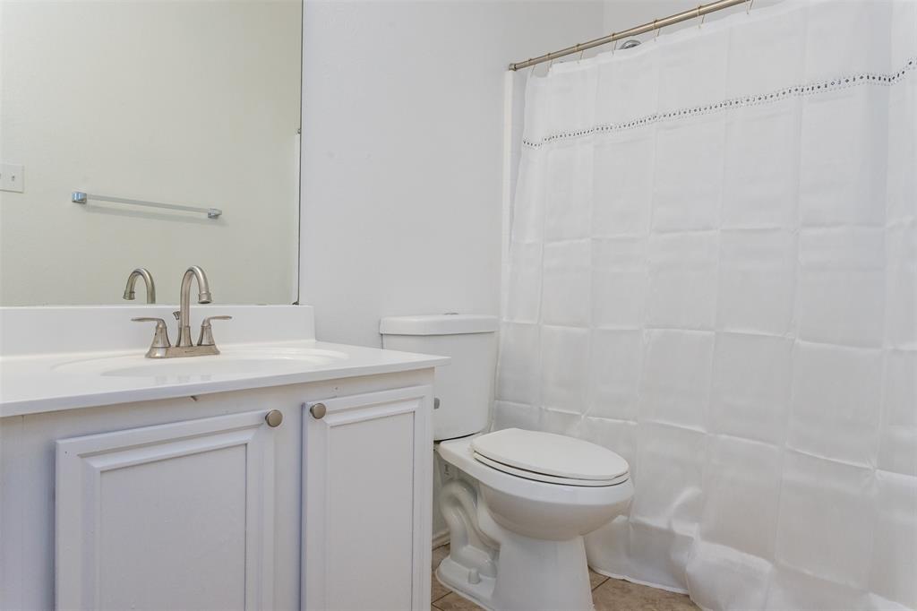 738 Opal Lane Mesquite, TX 75149 - Photo 25 of 31 Bathroom featuring vanity, light tile patterned floors, and curtained shower