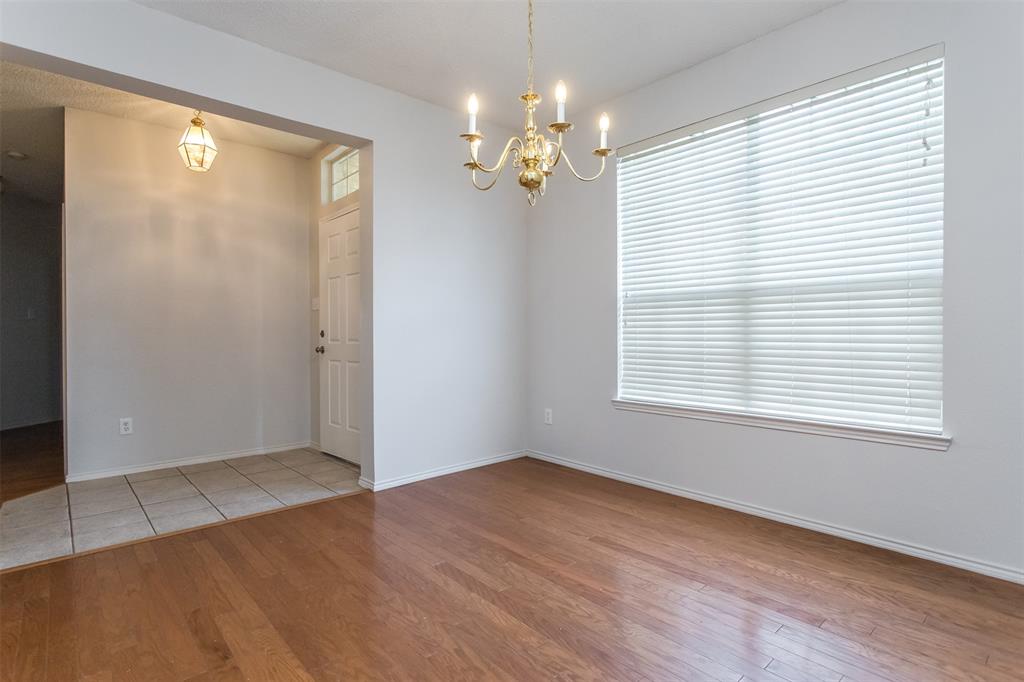 738 Opal Lane Mesquite, TX 75149 - Photo 3 of 31 Unfurnished room with light wood-style floors and a chandelier