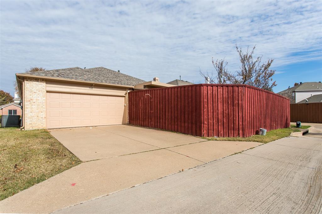 738 Opal Lane Mesquite, TX 75149 - Photo 30 of 31 View of home's exterior with concrete driveway, brick siding, a gate, and a shingled roof