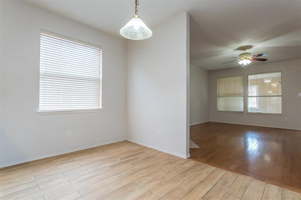 738 Opal Lane Mesquite, TX 75149 - Photo 9 of 31 Empty room featuring light wood-style floors, healthy amount of natural light, and a ceiling fan