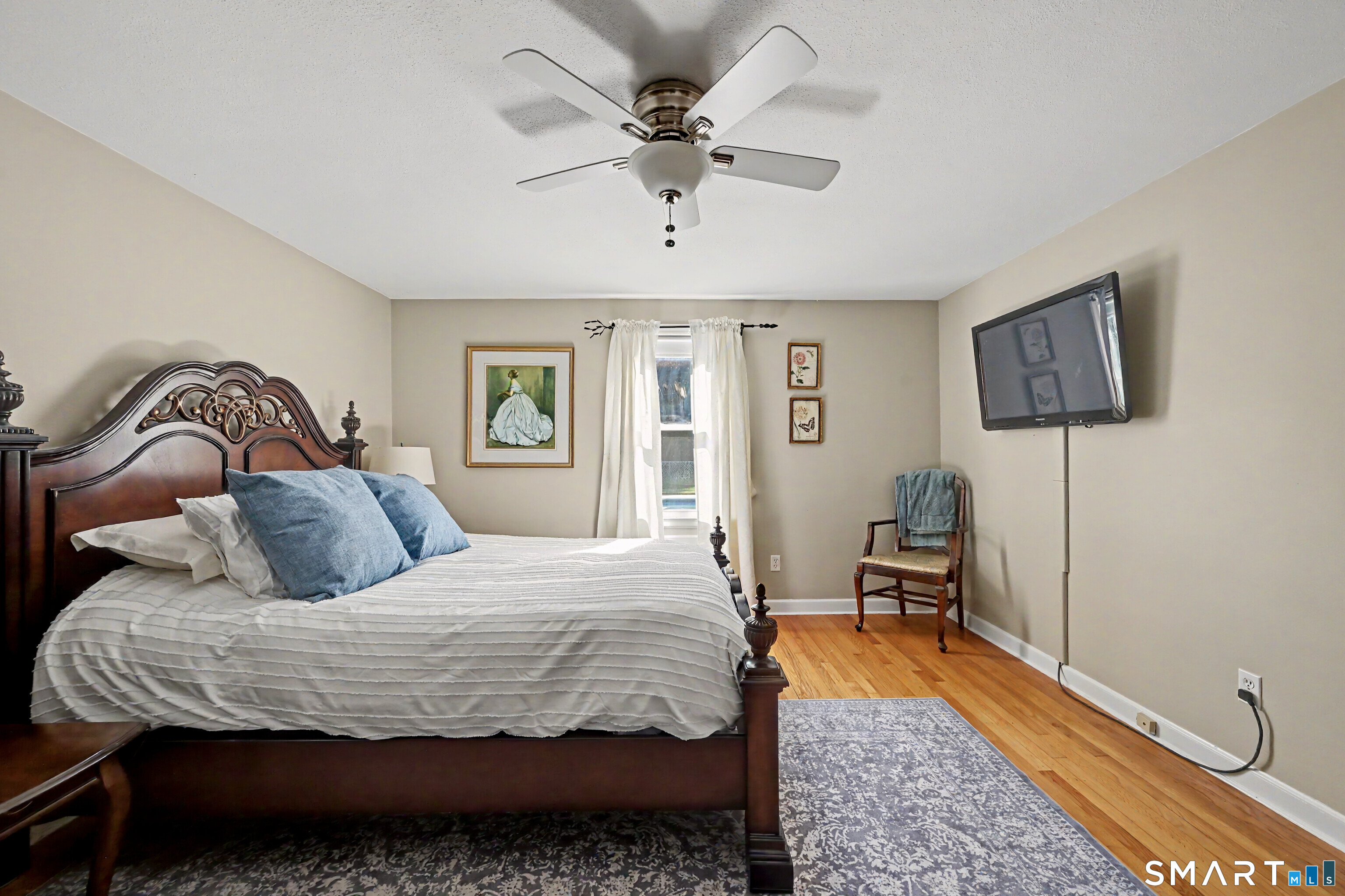 524 Ferry Road Orange, CT 06477 - Photo 24 of 40 a bedroom with a bed and wooden floor