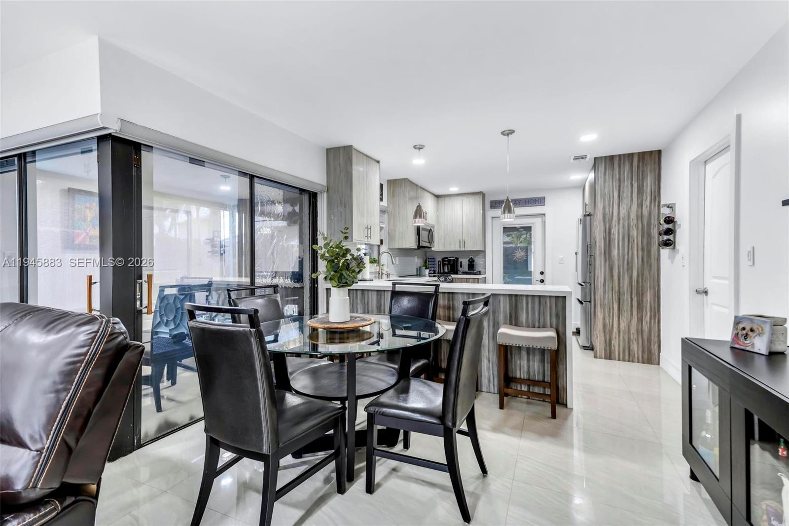 12736 Southwest 68th Lane Miami, FL 33183 - Photo 11 of 37 a view of a dining room with furniture and a large window