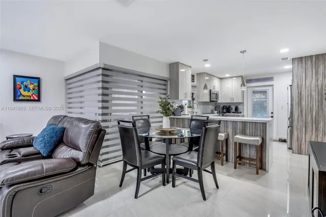 a dining room with furniture and window