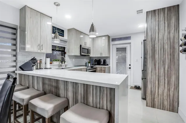 a kitchen with a table chairs sink and cabinets