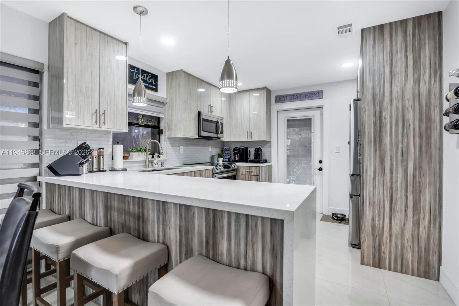 12736 Southwest 68th Lane Miami, FL 33183 - Photo 14 of 37 a kitchen with a table chairs sink and cabinets