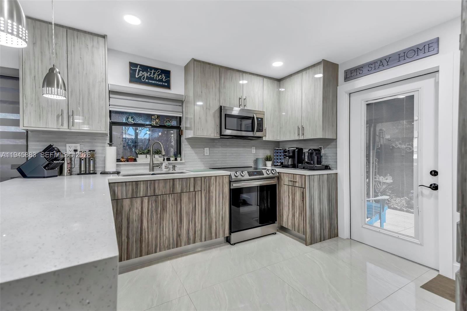 12736 Southwest 68th Lane Miami, FL 33183 - Photo 17 of 37 a kitchen with stainless steel appliances granite countertop a refrigerator sink and stove