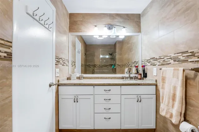 a bathroom with a sink vanity and a mirror