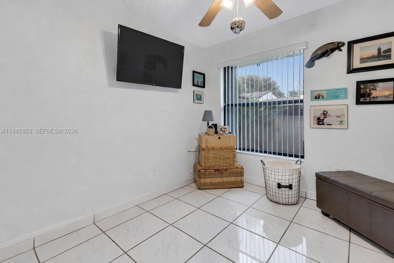 12736 Southwest 68th Lane Miami, FL 33183 - Photo 24 of 37 a living room with furniture and a flat screen tv