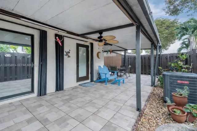 a view of a chairs and table in backyard of the house
