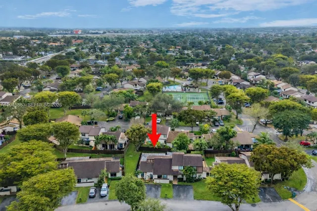 an aerial view of residential house with green space and lake view