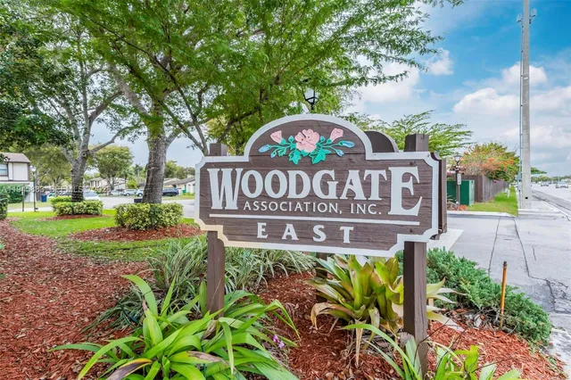 a view of a street sign under a large tree