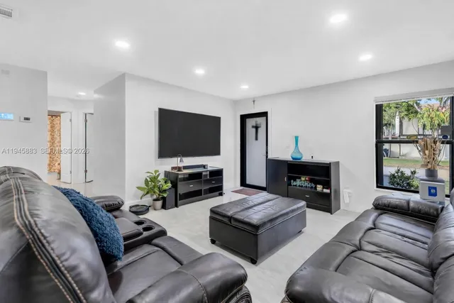 a living room with furniture a fireplace and a flat screen tv