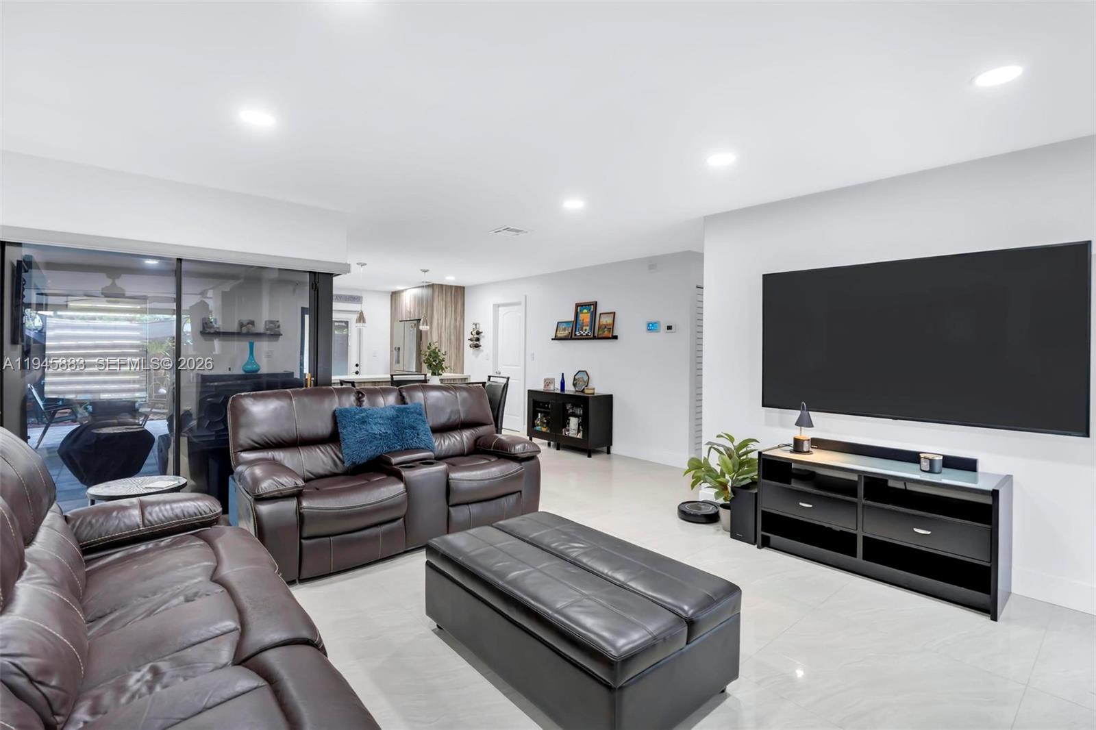 12736 Southwest 68th Lane Miami, FL 33183 - Photo 6 of 37 a living room with furniture and a flat screen tv