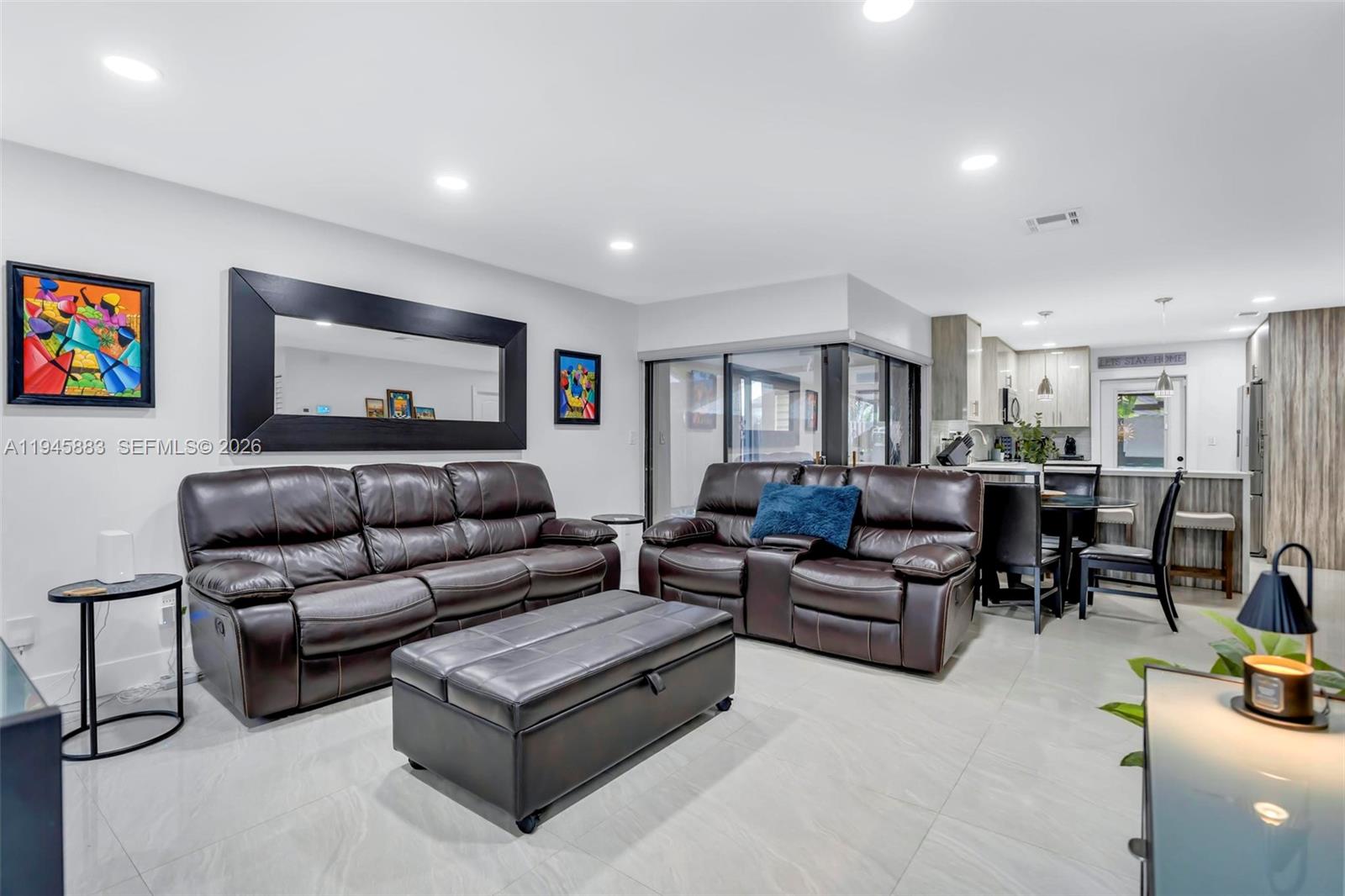 12736 Southwest 68th Lane Miami, FL 33183 - Photo 7 of 37 a living room with furniture and a flat screen tv