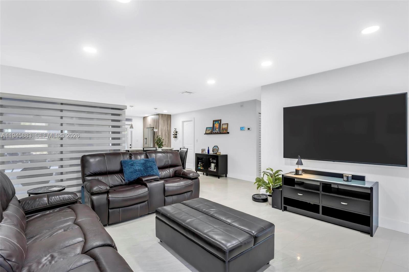 12736 Southwest 68th Lane Miami, FL 33183 - Photo 9 of 37 a living room with furniture and a flat screen tv