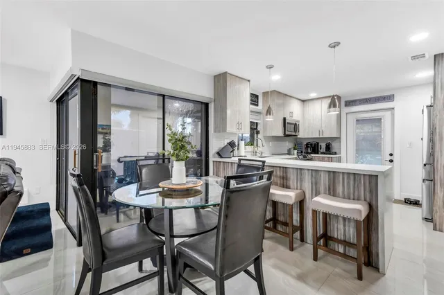 a view of a dining room with furniture and a table