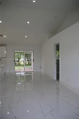 an empty room with large windows