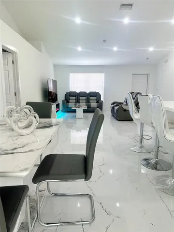 a kitchen with stainless steel appliances kitchen island granite countertop a sink and cabinets