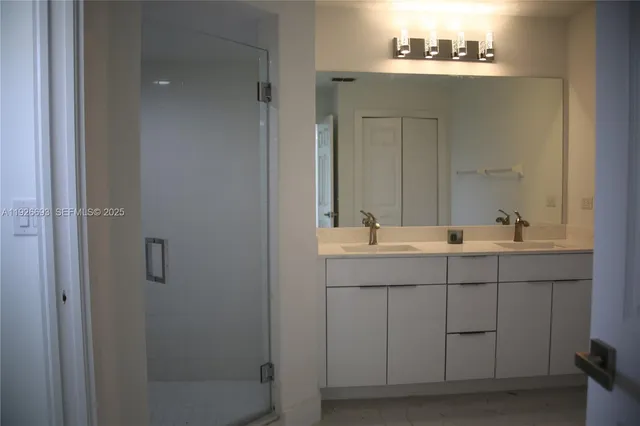 a bathroom with a sink vanity and mirror