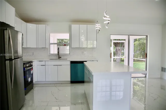 a kitchen with kitchen island granite countertop a stove cabinets and refrigerator