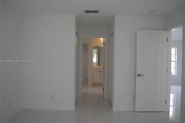 a view of a hallway with a wooden cabinets