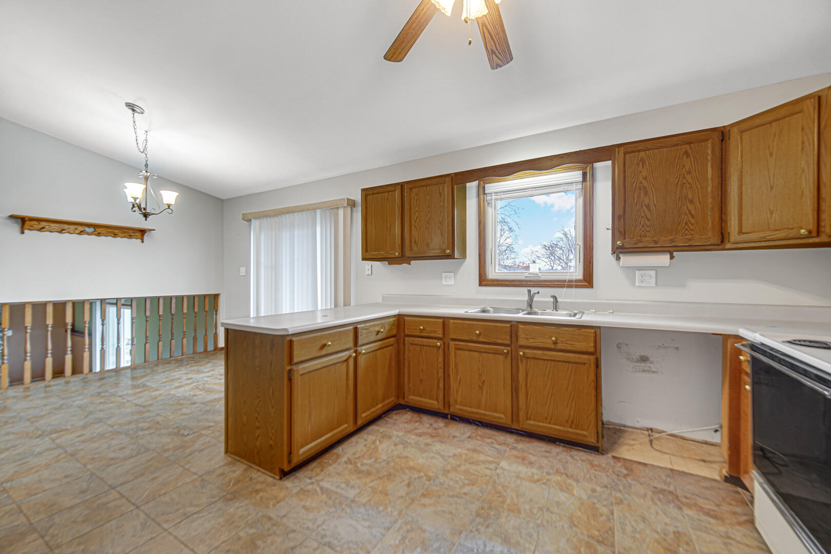 700 Meadow Lane Crown Point, IN 46307 - Photo 11 of 28 a kitchen with granite countertop a stove a sink a window and dining table