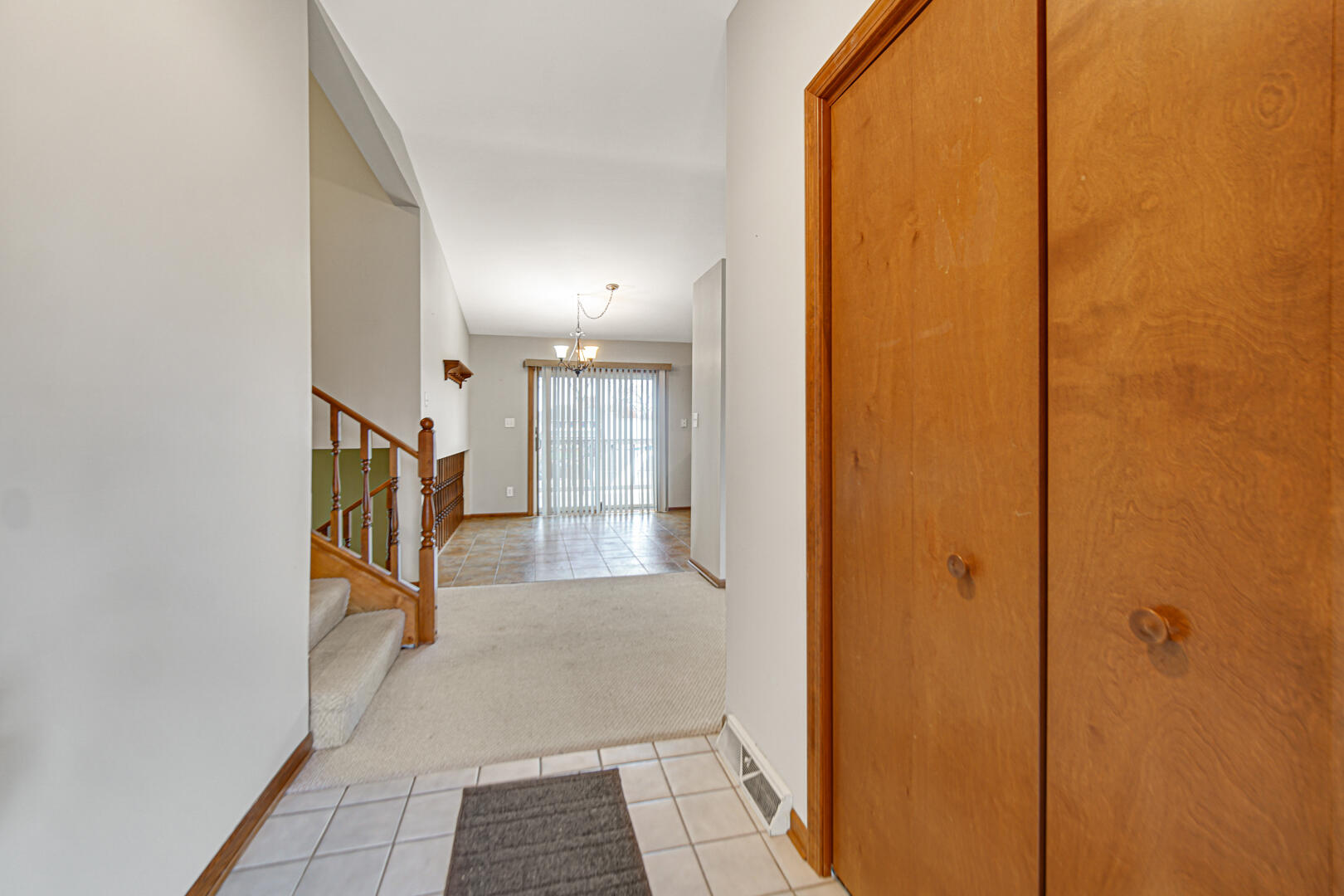 700 Meadow Lane Crown Point, IN 46307 - Photo 7 of 28 a view of a hallway with wooden floor and staircase