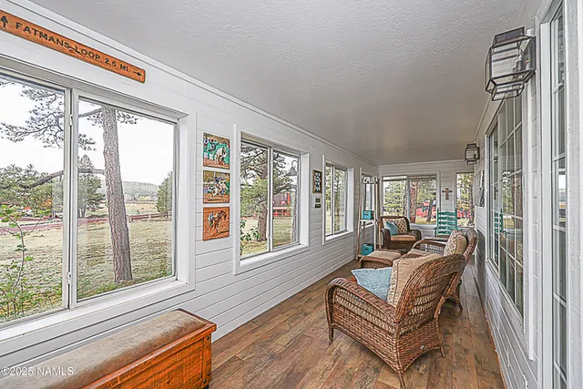 a dining room with furniture window and wooden floor