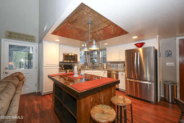 a living room with furniture a clock on wall and a large window