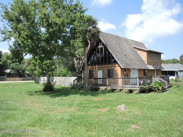 6990 Boston Road Cocoa, FL 32927 - Photo 2 of 26 a view of a house with a yard
