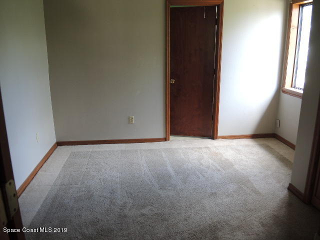 6990 Boston Road Cocoa, FL 32927 - Photo 17 of 26 a view of an empty room and a window